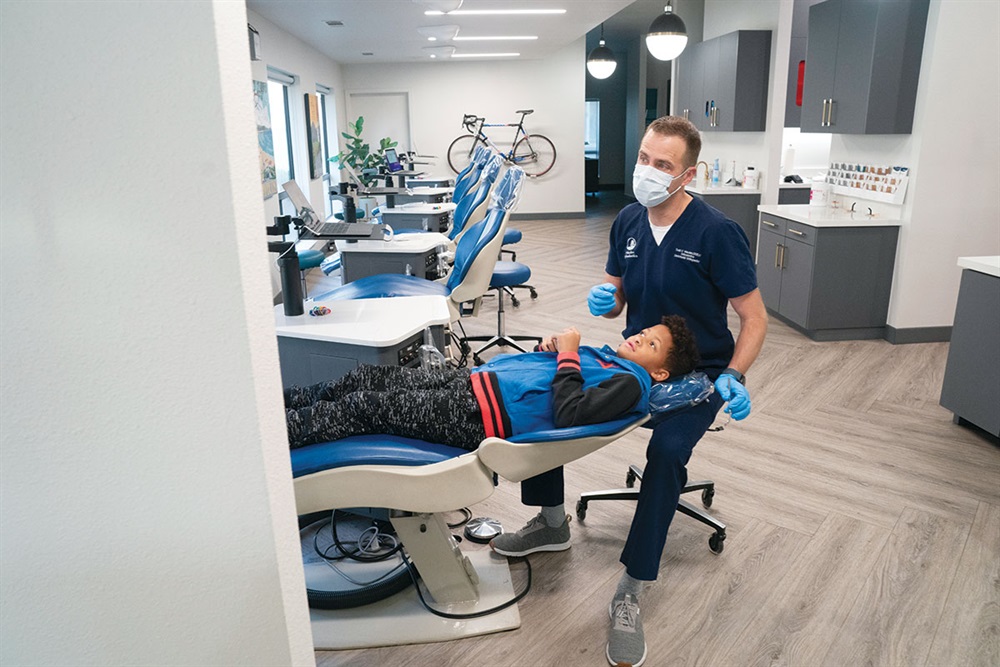 Dr. Wesslen talking with a young patient in the clinic